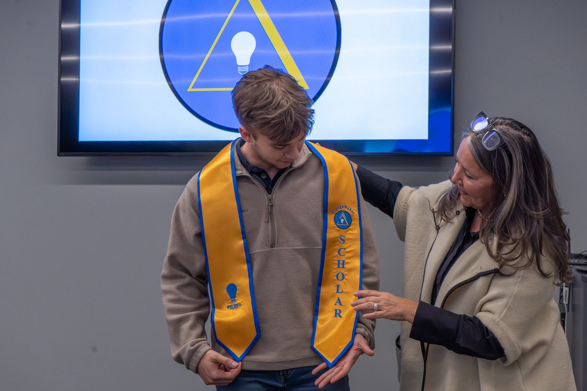 Jack Pearson receives his ChangeMaker Scholar graduation regalia  