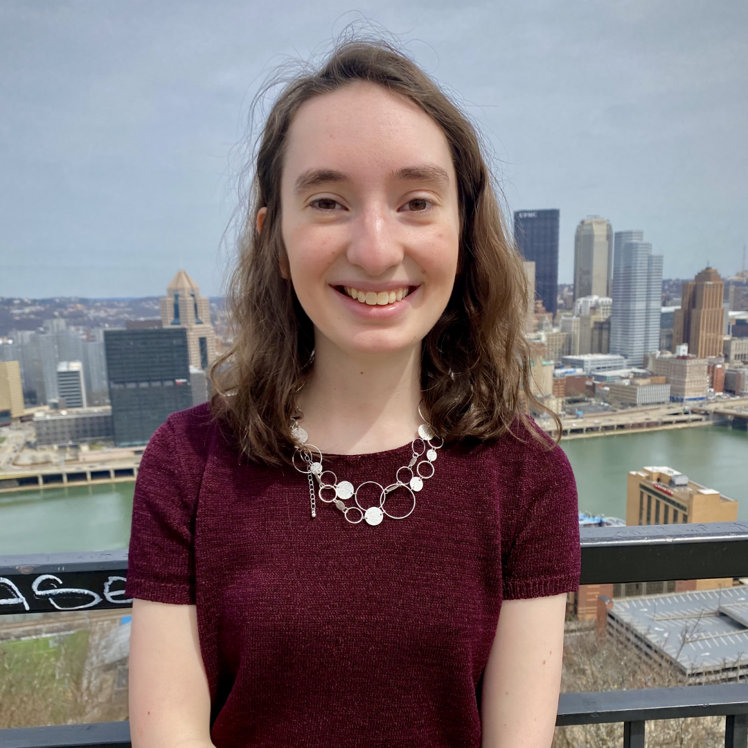 Heather smiling with Pittsburgh skyline in the background